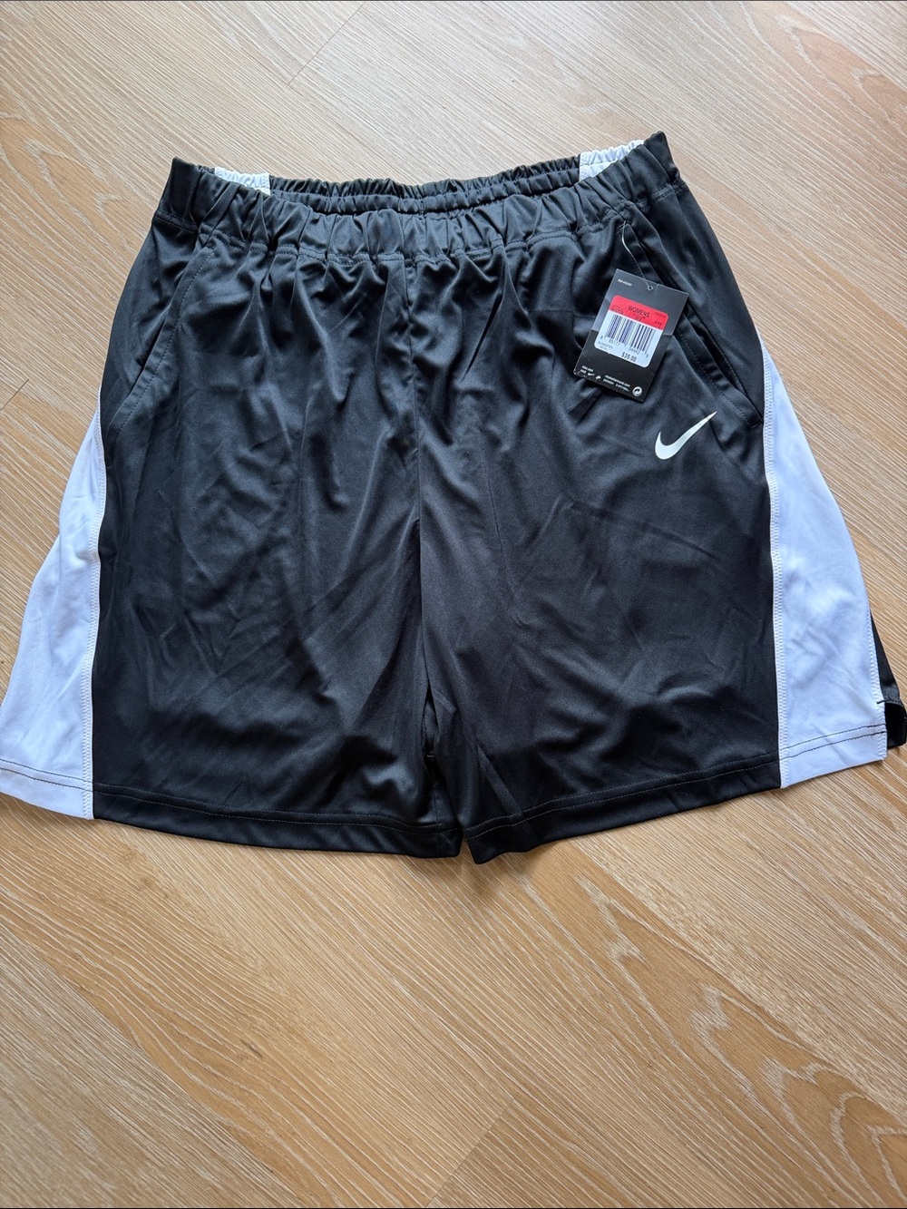 Nike Women’s Black Athletic Shorts with White Side Panels and pockets